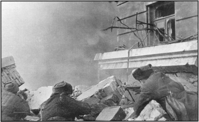 Street fighting on the outskirts of Stalingrad. Showing Red Army me attempting to dislodge Germans from a house. [Gelatin silver photograph. Printed USSR, no. 11622, dated January 1943. Argus Collection, Box 57B] [photograph]