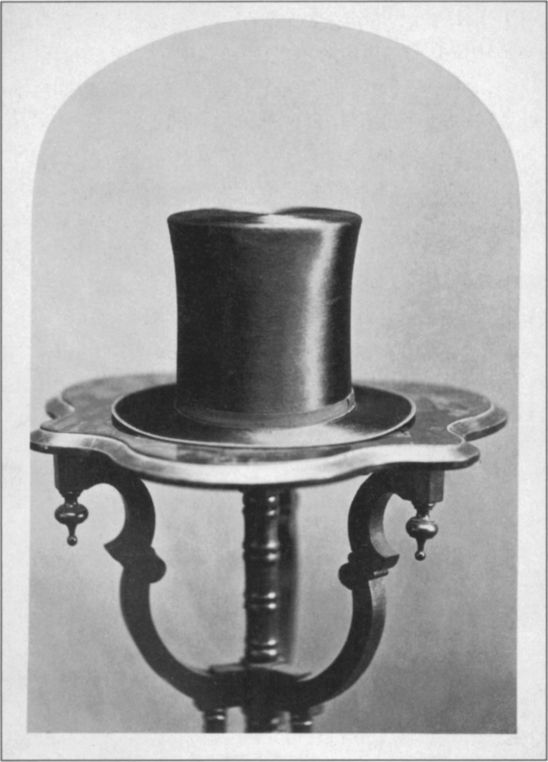 Left: Bradley and Rulofson photographic studio, San Francisco. 1876. Redmond Barry's new top hat on table.  [mounted photograph]