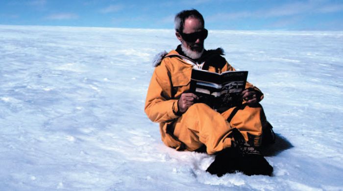 Below: Tom Griffiths sitting on ice reading Stephen Murray-Smith’s Sitting on Penguins. (Photograph by Jenni Mitchell. Reproduced courtesy of Jenni Mitchell and Tom Griffiths) [colour photograph]
