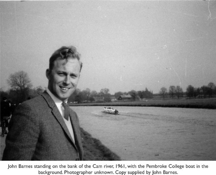 Photograph of John Barnes standing on the bank of the Cam river, 1961, with the Pembroke College boat in the background. Photographer unknown. Copy supplied by John Barnes. [photograph]