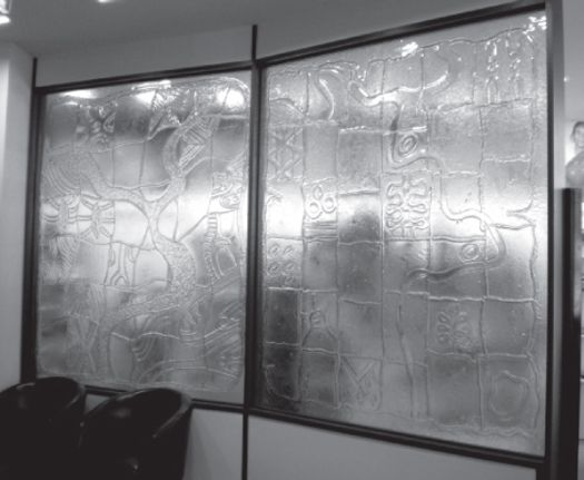 Figure 7 Glass panels, Oxfam offices, Carlton, by Maree Clarke (left) and Lee Darroch (right),  2007. Copyright artists. [interior, glass wall panels]