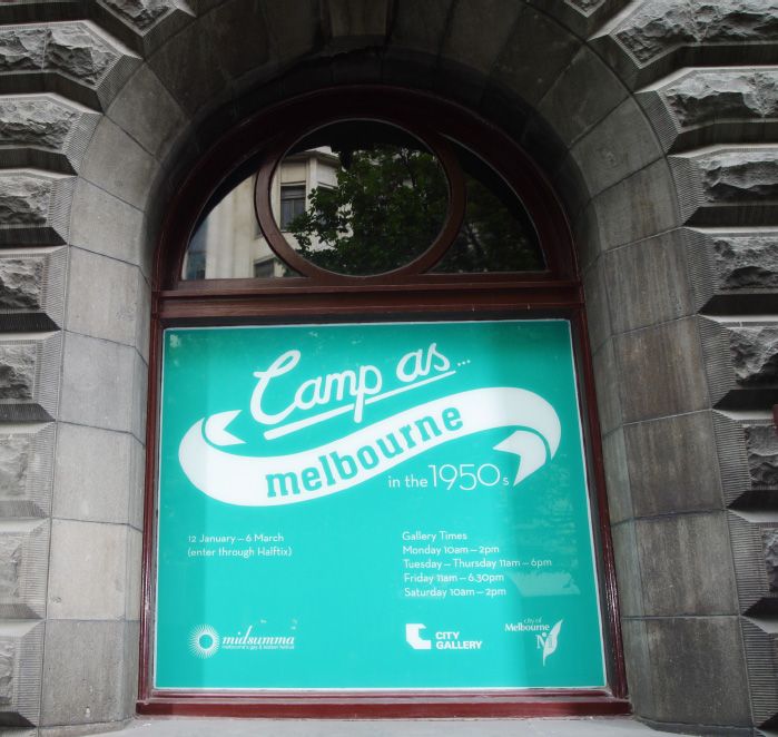 Notice in venue window promoting the Camp as. . . Melbourne in the 1950s exhibition held in the Melbourne Town Hall in 2005. [Photograph]